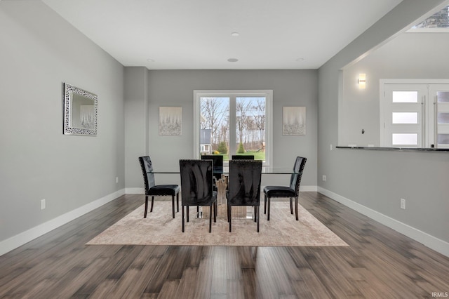dining room featuring baseboards and dark wood finished floors