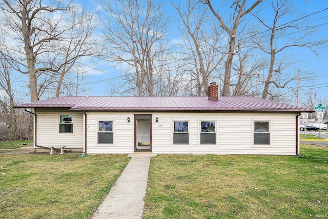 619 Widaman St, Warsaw, IN 46580 - single story home with a front yard, metal roof, and a chimney