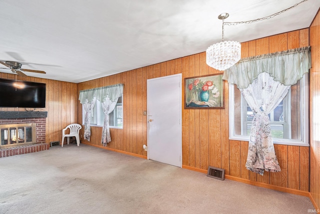619 Widaman St, Warsaw, IN 46580 - unfurnished living room with a healthy amount of sunlight, carpet flooring, ceiling fan with notable chandelier, and visible vents