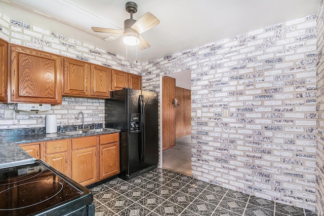 619 Widaman St, Warsaw, IN 46580 - kitchen featuring dark countertops, black appliances, brown cabinetry, ceiling fan, and a sink