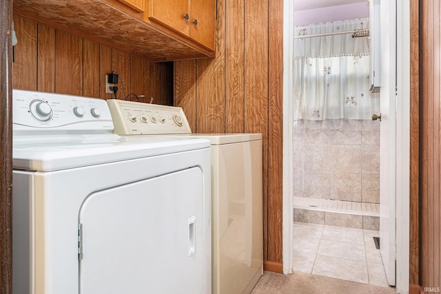 619 Widaman St, Warsaw, IN 46580 - laundry area with washing machine and clothes dryer, cabinet space, and light tile patterned floors