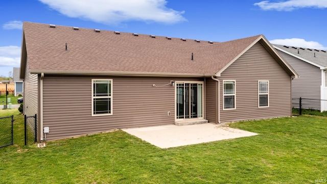 rear view of house with a yard, fence, a patio, and roof with shingles