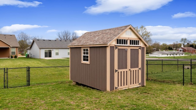 view of shed with a fenced backyard and a gate