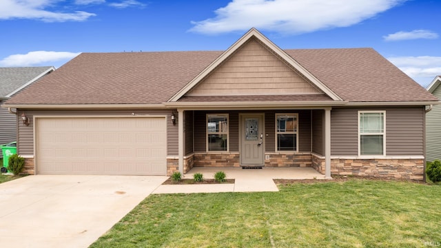 view of front of property featuring an attached garage, concrete driveway, a front yard, and stone siding