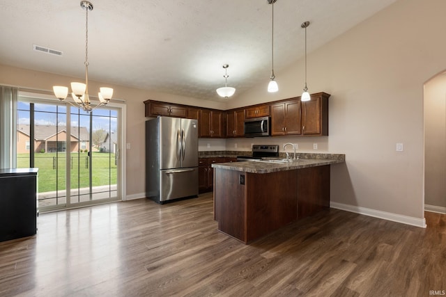 kitchen with baseboards, a peninsula, dark countertops, visible vents, and appliances with stainless steel finishes