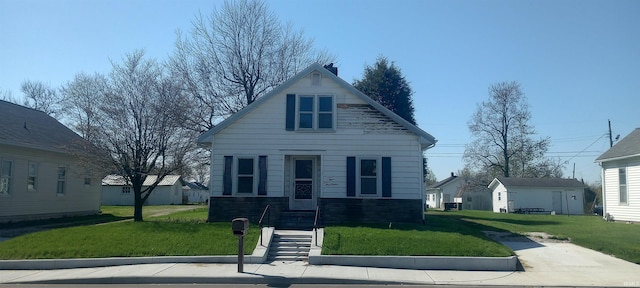 bungalow-style house with a front lawn