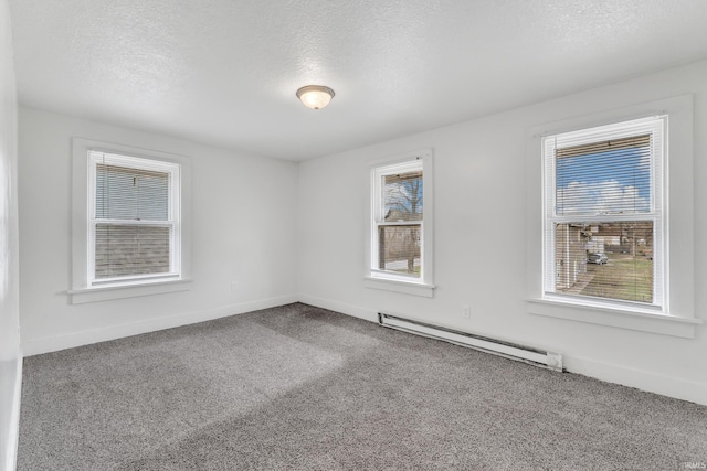 empty room featuring baseboards, a baseboard radiator, a textured ceiling, and carpet floors