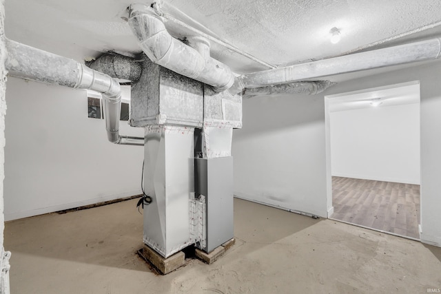 unfinished below grade area with a textured ceiling and baseboards