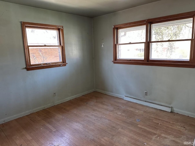1501 Lafayette St, Valparaiso, IN 46383 - spare room featuring wood-type flooring, a baseboard radiator, and baseboards