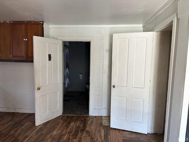 unfurnished bedroom featuring dark wood-style floors