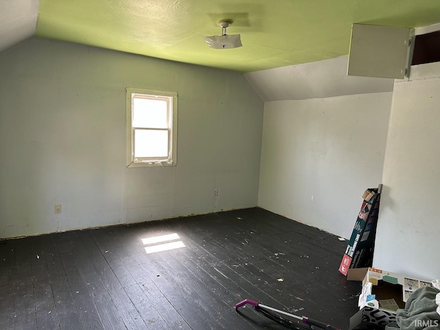 bonus room with hardwood / wood-style floors and lofted ceiling