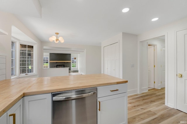 kitchen featuring a notable chandelier, dishwasher, recessed lighting, light wood finished floors, and butcher block countertops