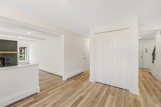 interior space with baseboard heating and light wood-type flooring