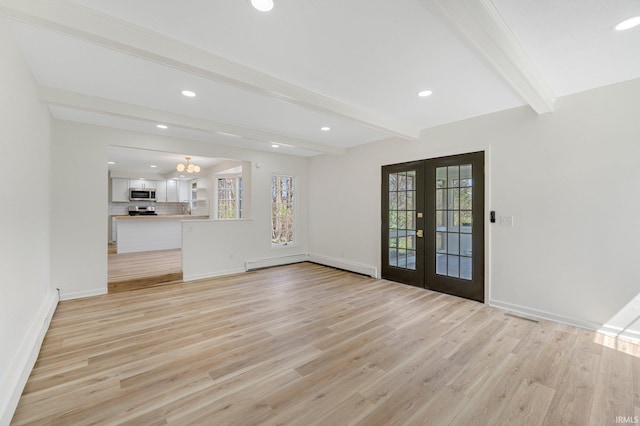 unfurnished living room featuring baseboard heating, beam ceiling, light wood finished floors, recessed lighting, and french doors