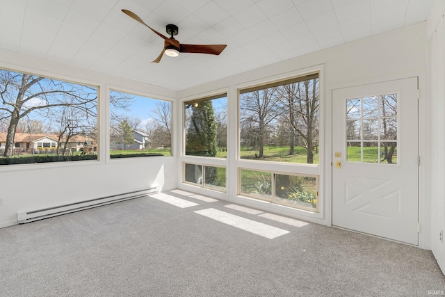 unfurnished sunroom featuring a baseboard radiator and carpet