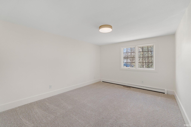 empty room with carpet floors, baseboards, and baseboard heating