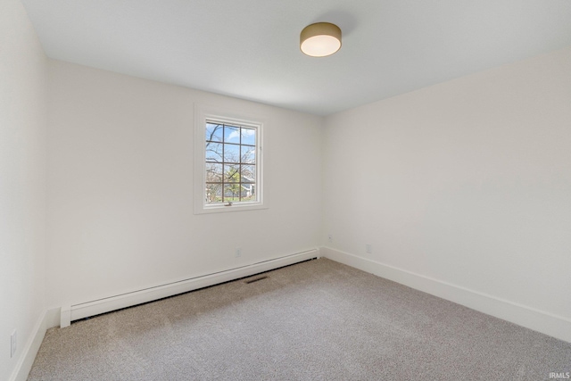 unfurnished room featuring carpet, a baseboard heating unit, and baseboards