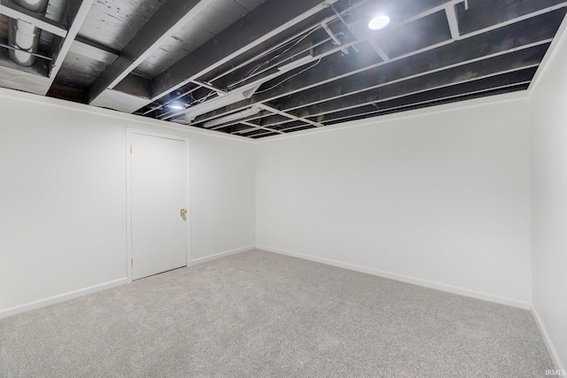 finished basement featuring baseboards and carpet