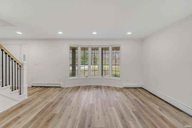 unfurnished living room featuring light wood-style floors, crown molding, recessed lighting, stairs, and a baseboard heating unit