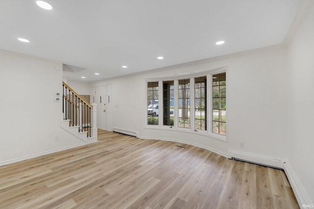 unfurnished living room featuring recessed lighting, stairway, a baseboard heating unit, and light wood finished floors