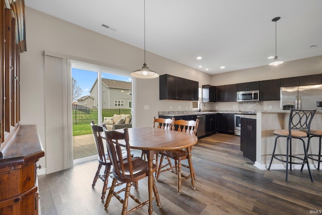 dining area featuring dark wood-style floors, visible vents, and recessed lighting