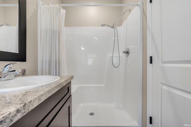 bathroom with a stall shower and vanity