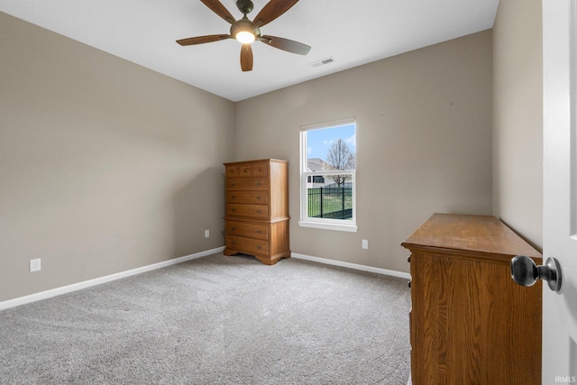 interior space with visible vents, baseboards, and a ceiling fan