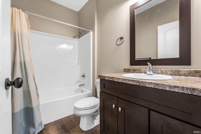 bathroom with toilet, wood finished floors, vanity, and shower / bath combo with shower curtain