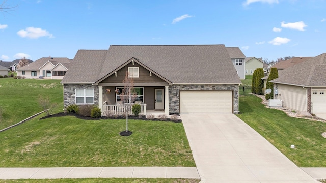 craftsman-style home with a porch, a shingled roof, stone siding, and a front lawn