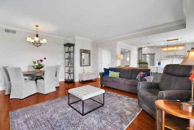 100 NW First St Unit 205, Evansville, IN 47708 - living area featuring a chandelier, wood finished floors, ornamental molding, and baseboards