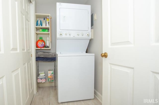 washroom with laundry area and stacked washer / drying machine