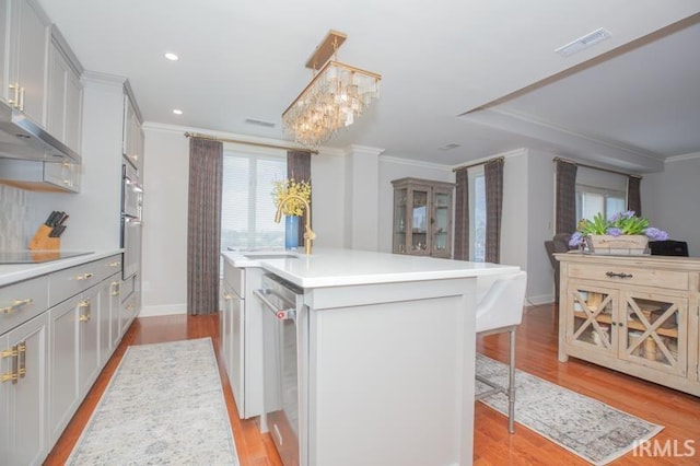kitchen featuring stainless steel dishwasher, ornamental molding, visible vents, a sink, and black electric cooktop