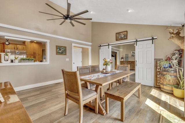 104 S Meridian Rd, Rochester, IN 46975 - dining room featuring visible vents, ceiling fan, a barn door, and light wood-style floors
