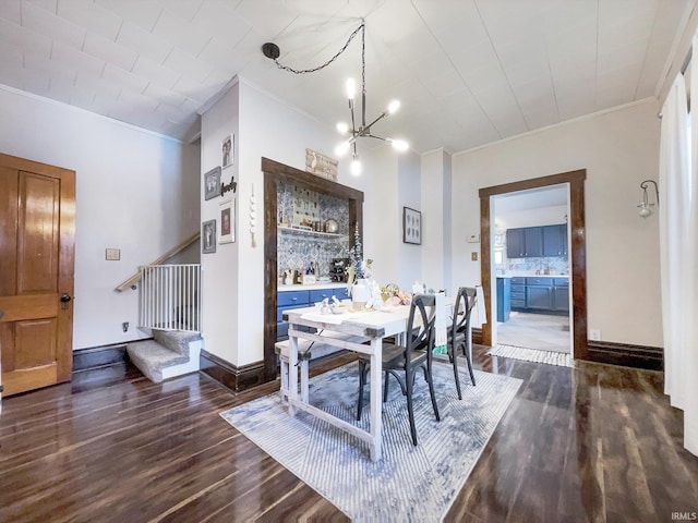 dining space featuring an inviting chandelier, ornamental molding, stairway, dark wood-style flooring, and baseboards