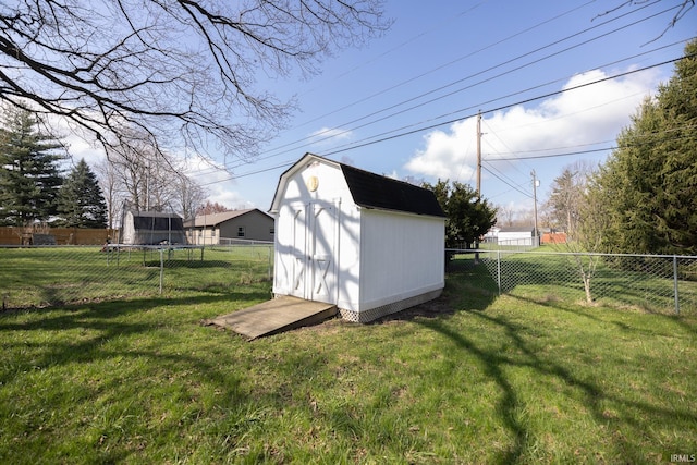 view of shed featuring a trampoline and a fenced backyard