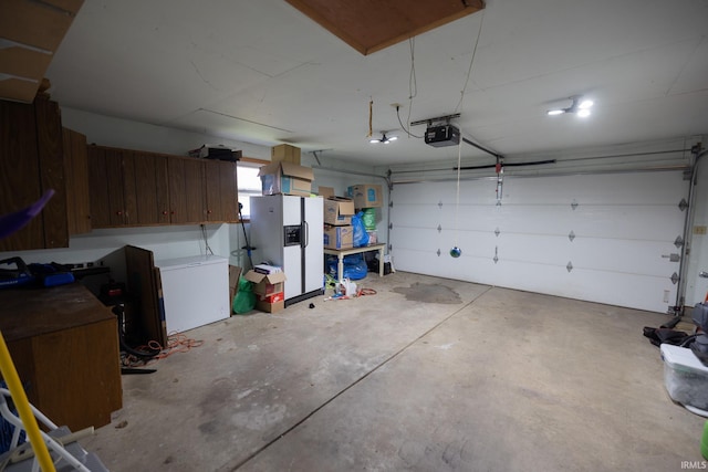 garage featuring a garage door opener and white fridge with ice dispenser