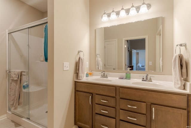 full bath with a sink, ensuite bathroom, double vanity, and a stall shower