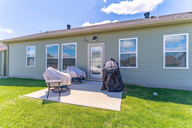 back of house with a patio and a yard