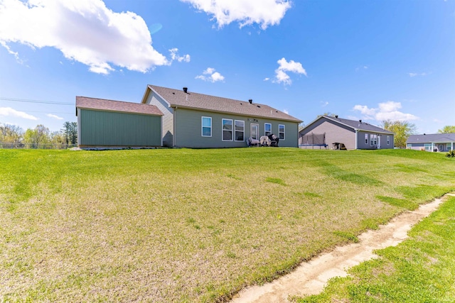 rear view of house featuring a lawn