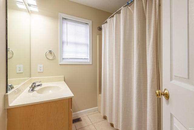 bathroom with vanity, a shower with curtain, tile patterned flooring, visible vents, and baseboards