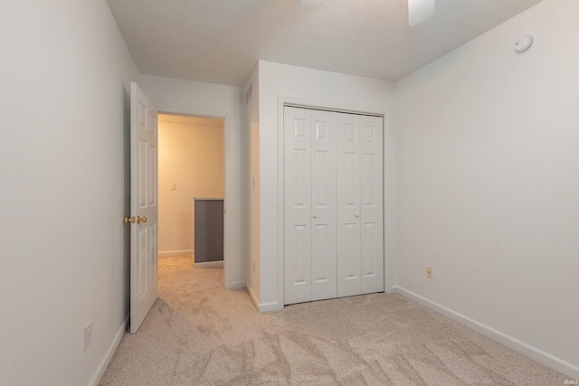 unfurnished bedroom with a closet, baseboards, and carpet