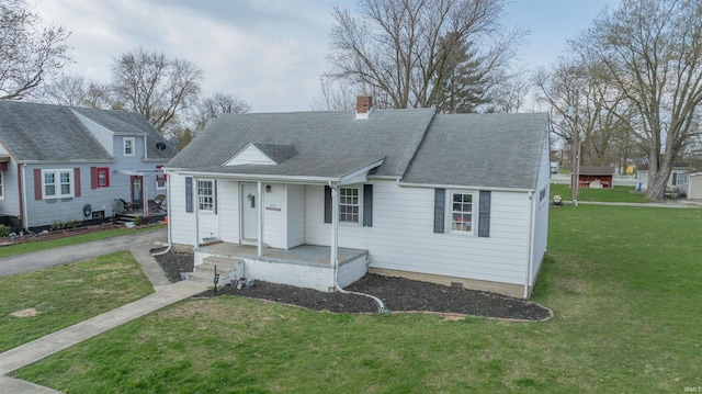view of front of property with a chimney, covered porch, and a front lawn