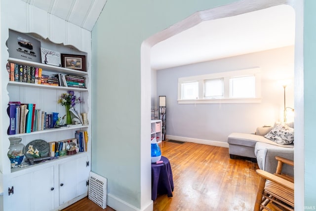 living area with wood finished floors and baseboards