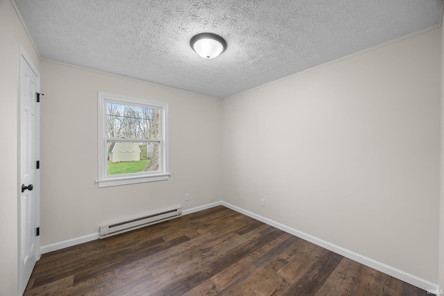 spare room with a textured ceiling, a baseboard heating unit, baseboards, and dark wood finished floors