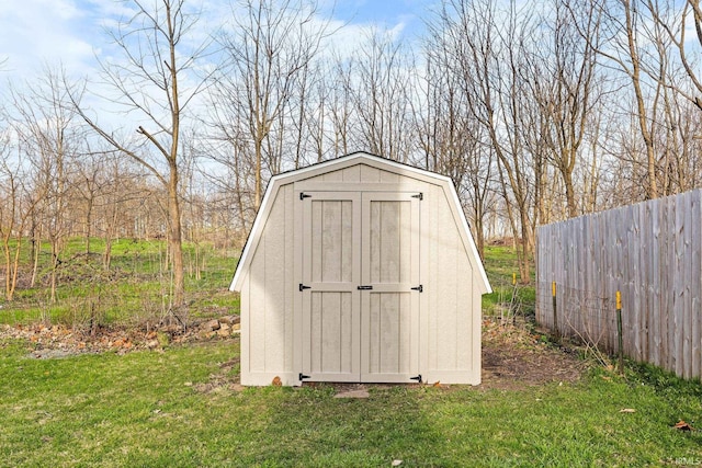 view of shed featuring fence