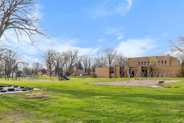 surrounding community with a yard and playground community
