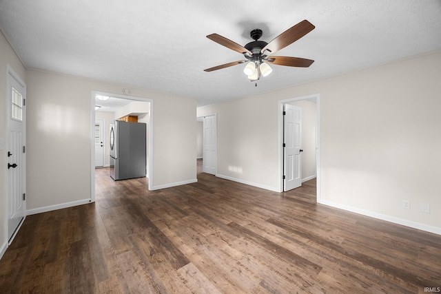 unfurnished living room featuring wood finished floors, ceiling fan, and baseboards
