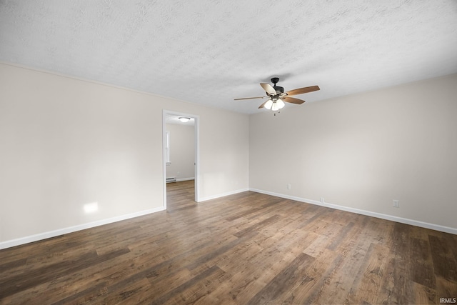 unfurnished room with a textured ceiling, dark wood-style flooring, baseboards, and a ceiling fan