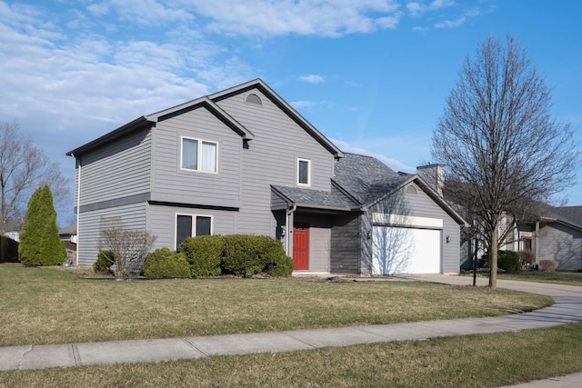 traditional home with a front yard, a garage, and concrete driveway