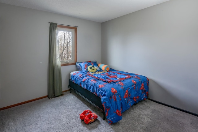 carpeted bedroom featuring baseboards